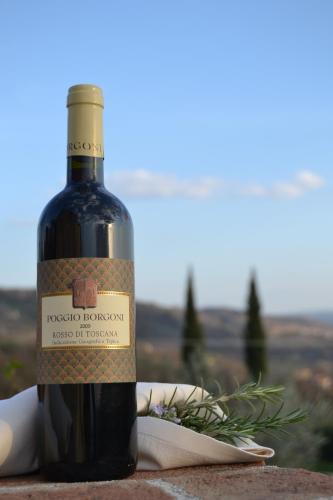 a bottle of wine sitting on top of a table at Relais Poggio Borgoni in San Casciano in Val di Pesa