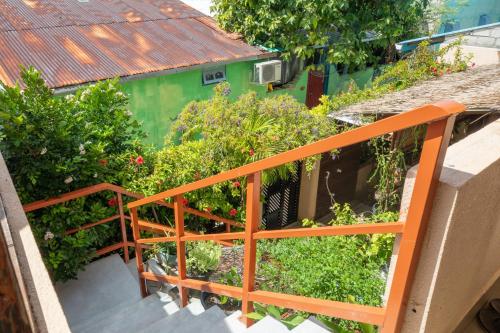 a balcony with an orange railing and some plants at Nemo Inn in Omadhoo