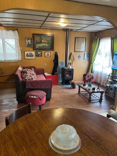 a living room with a couch and a table at Habitación cómoda por día in Valdivia