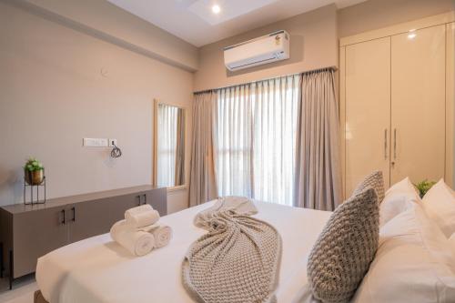 a hotel room with a bed with towels on it at Alaya Stays 3 BHK Veera Marina Pentahouse with Pool & Lift in Candolim