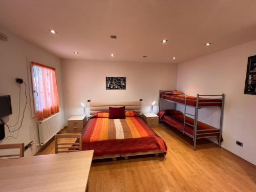 a bedroom with a bed and two bunk beds at Residence Stefania Cavasso Nuovo in Cavasso Nuovo