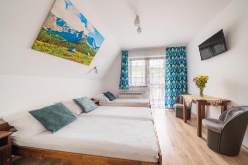 a living room with a bed and a couch at Willa Widokowa in Czarna Góra