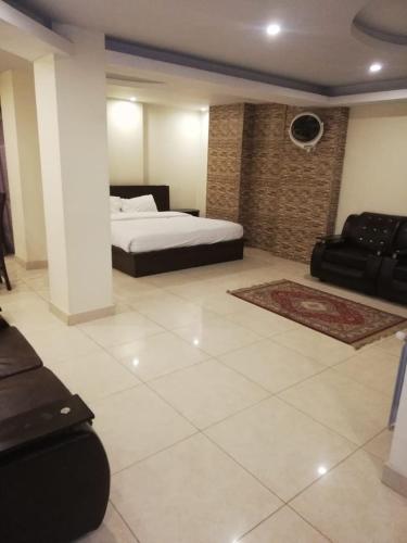 a large room with a bed and a couch at Ambassador Inn in Islamabad