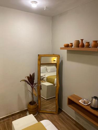 a mirror in the corner of a room with a bed at Achalaa Resort in Kolhapur