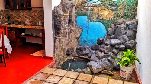 a painting of a creek in a room with rocks at Stylish Escape House-Walk to Beach Vacation Rental Hikkaduwa in Hikkaduwa