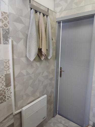 a bathroom with a shower door and towels at Samy in Sarajevo