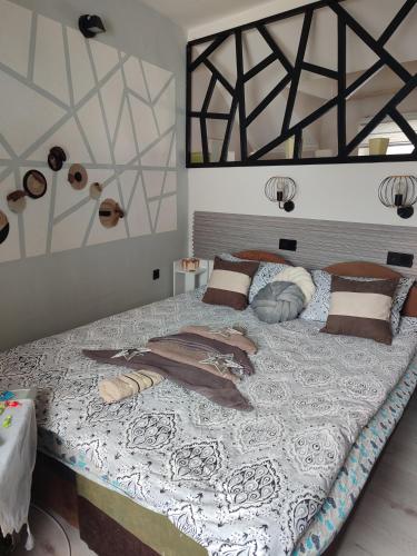a large bed with pillows on it in a bedroom at Samy in Sarajevo