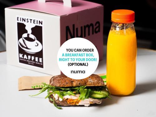 a sandwich next to a bottle of orange juice at Numa Berlin Nook in Berlin