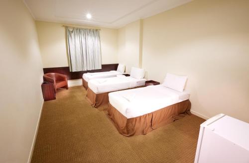 Ένα ή περισσότερα κρεβάτια σε δωμάτιο στο Al Zaereen Hotel 2