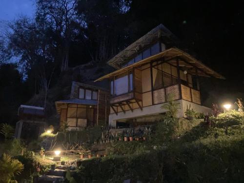 a house on a hill at night at Art Mile Kalimpong in Kalimpong
