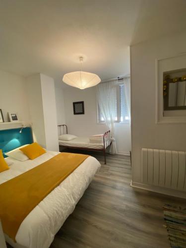 a bedroom with a large bed and a table at Rance solidor ter in Saint Malo