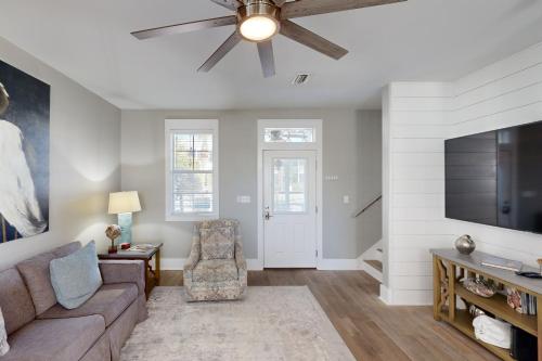 a living room with a couch and a ceiling fan at Gone Coastal B23 in Highland View