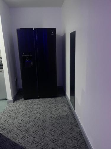 a black door in a room with a wall at D'Chin Dorcelle Suite in Norbury