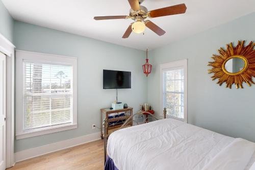 a bedroom with a bed and a ceiling fan at Gone Coastal B23 in Highland View