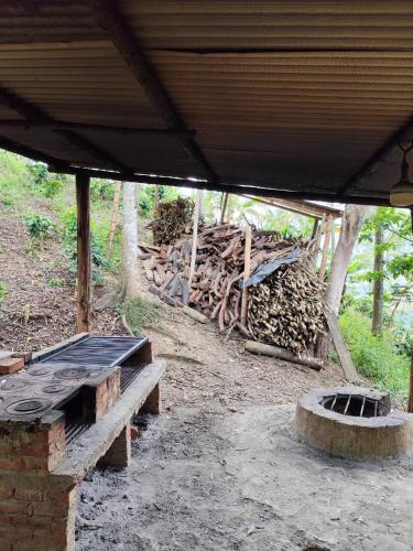 a building with a pile of wood and a bench at Mirador de Germain in Pacho