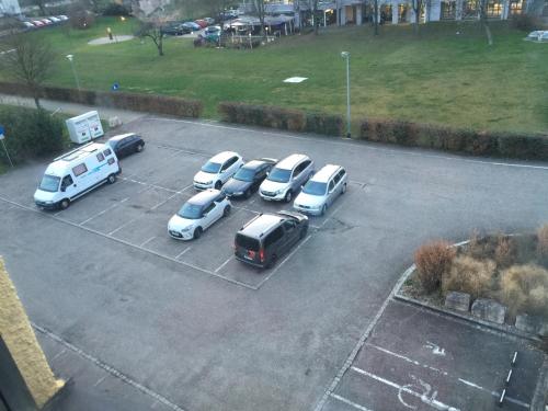 a group of cars parked in a parking lot at Hotel Adler in Grenzach-Wyhlen