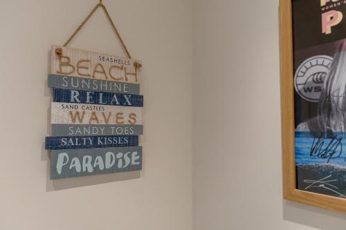 a sign hanging on a wall next to a picture at Foxglove Haven- 3-Bed Detached - Garden - Drive in Longridge
