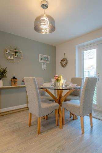 a dining room with a table and chairs at Foxglove Haven- 3-Bed Detached - Garden - Drive in Longridge