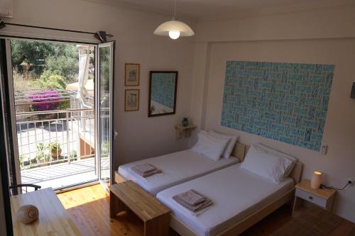 - une chambre avec 2 lits et une porte coulissante en verre dans l'établissement (301) Sea And Sun Apartments Kardamili, à Kardamyli