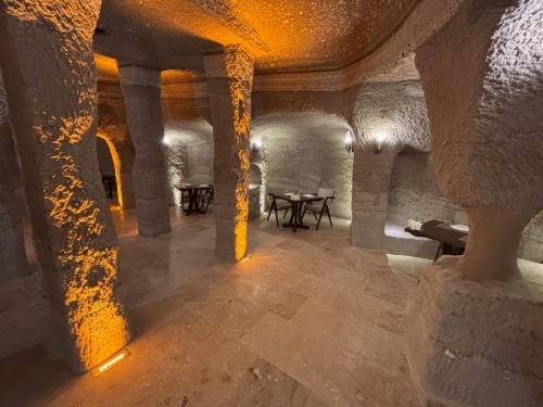 a room with columns and tables in a building at La Fairy Cappadocia in Uchisar
