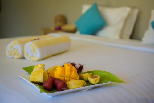 a plate of fruit on a table in a hotel room at Aquamarina Hotel in Jambiani