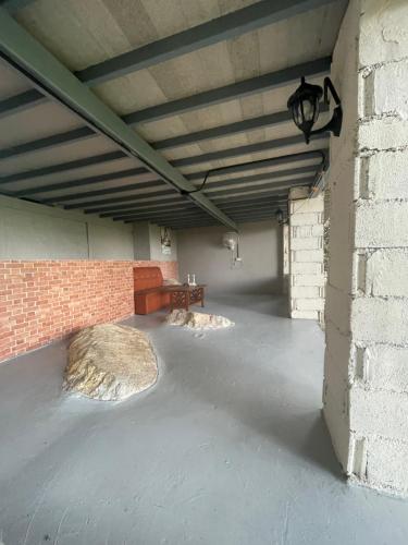 an empty parking garage with a brick wall at Shantaa in Wok Tum