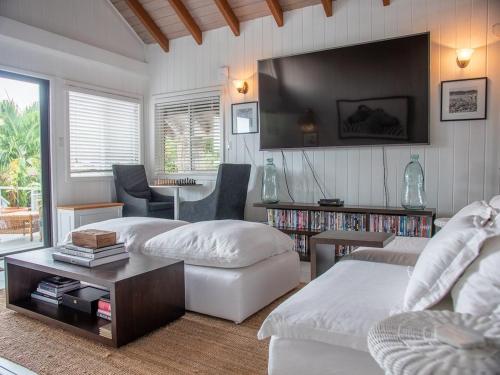 a living room with two beds and a table at The Seahouse Antigua SEAFRONT in Bats Cave