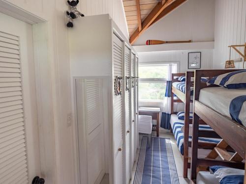 a room with two bunk beds and a hallway at The Seahouse Antigua SEAFRONT in Bats Cave
