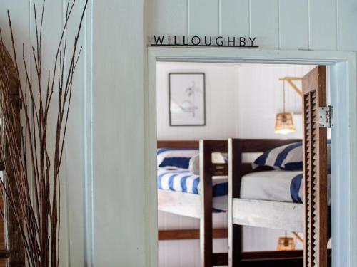 a bedroom with two bunk beds and a sign that reads wilderness at The Seahouse Antigua SEAFRONT in Bats Cave