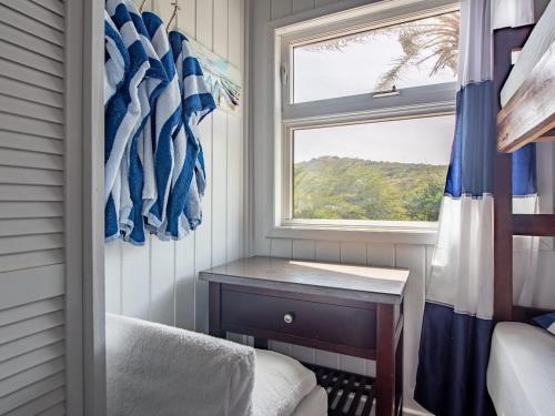 a small room with a window and a table at The Seahouse Antigua SEAFRONT in Bats Cave