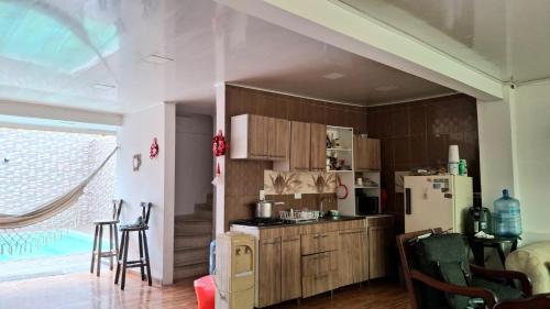a kitchen with wooden cabinets and a refrigerator at CASA QUINTA EL PARAiSo EN MESITAS DEL COLEGIO in El Colegio