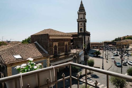 an old building with a clock tower in a city at B&B Don Diego Pedara in Pedara