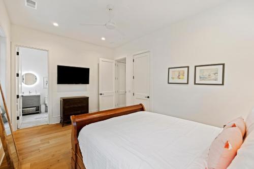 a white bedroom with a bed and a television at DP2931: 2931 Deer Point in Seabrook Island