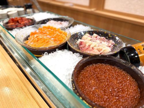a buffet of different types of food on a counter at Onyado Nono Kanazawa in Kanazawa