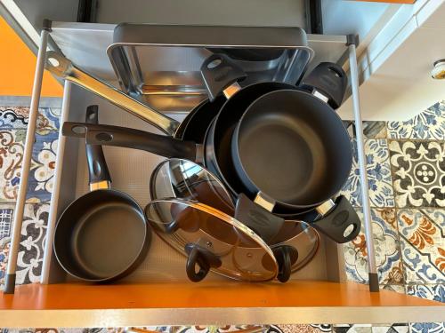 a bunch of pots and pans on a shelf at Vistadamare in Nettuno