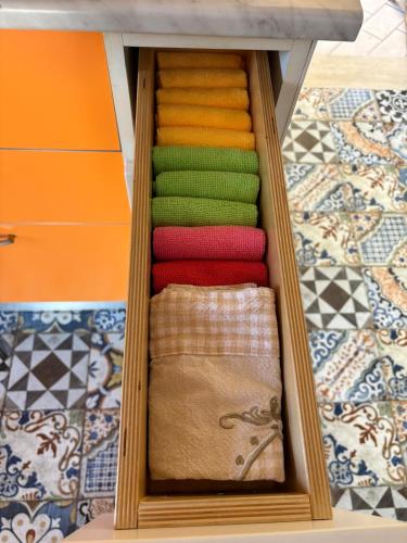 a wooden box filled with different colored towels at Vistadamare in Nettuno