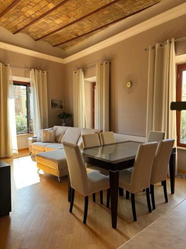 a living room with a table and chairs and a couch at Vistadamare in Nettuno