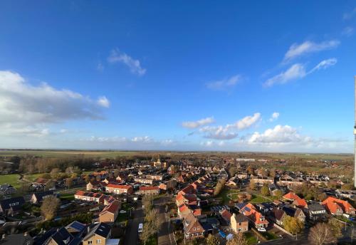 an aerial view of a town with houses at Watertorenhotel WADHOOG in Sint Jacobiparochie