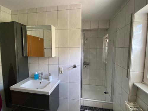 a bathroom with a sink and a shower at Ferienwohnung Alexa an der Dhron in Neumagen-Dhron