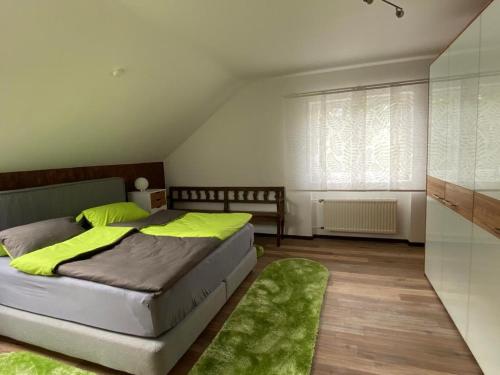 a bedroom with a bed and a green rug at Ferienwohnung Alexa an der Dhron in Neumagen-Dhron