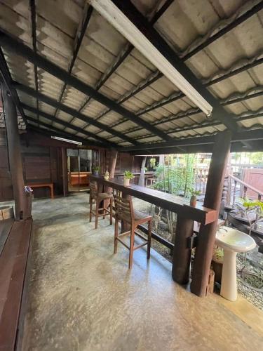 a room with tables and chairs in a building at The Bodhi House in Chiang Mai