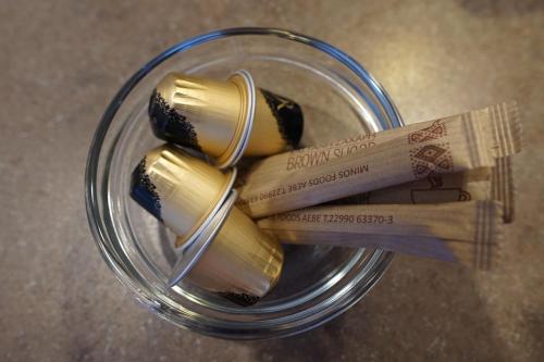 a glass jar filled with gold and cinnamon sticks at Sea And Sun apartments 304 Ιδιωτικό διαμέρισμα in Kardamili
