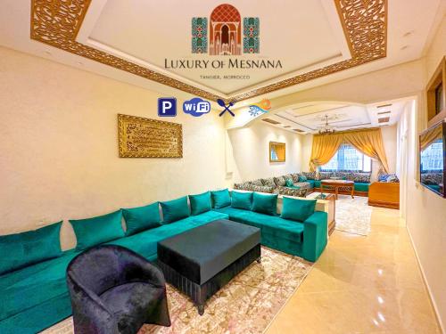 a living room with a green couch and chairs at Luxury of Mesnana - Stay with low budget in Tangier