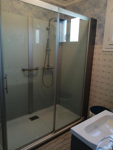 une douche avec une porte vitrée dans une salle de bain dans l'établissement Colette chambre chez l'habitant, à Carhaix-Plouguer
