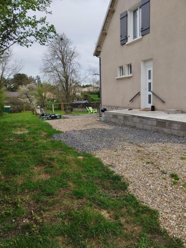 a house with a gravel driveway in front of it at Le gite d 'Amélie maison rénovée 6 couchages 2 salles de bains in Célon