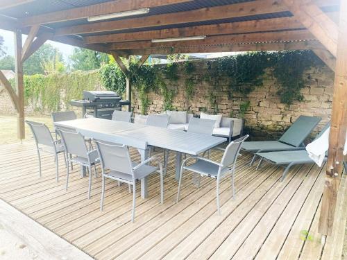 a white table and chairs on a wooden deck at Grande Maison Luxeuil 6 chambres in Luxeuil-les-Bains