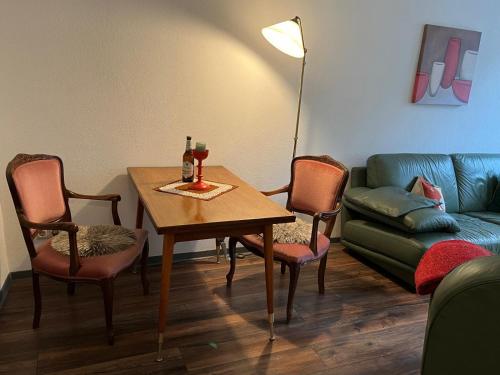 a living room with a table and a couch at Schicke Ferienwohnung in der Altstadt in Annaberg-Buchholz