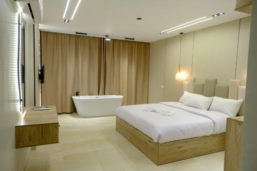 a bedroom with a large bed and a bath tub at Pyramids Height Hotel & Pyramids Master Scene Rooftop in Cairo