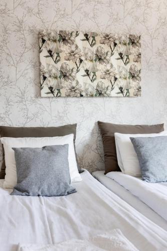 a bedroom with two beds and a painting on the wall at Santa's Holiday Homes in Rovaniemi