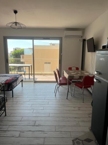 d'un salon avec une table et des chaises ainsi que d'une terrasse. dans l'établissement Spacieux studio plein sud et très calme, à Cagnes-sur-Mer